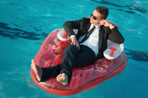 man-in-suit-in-pool-on-float-shutterstock_151117196