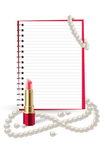 Beauty and fashion background with open notebook, lipstick and pearls.